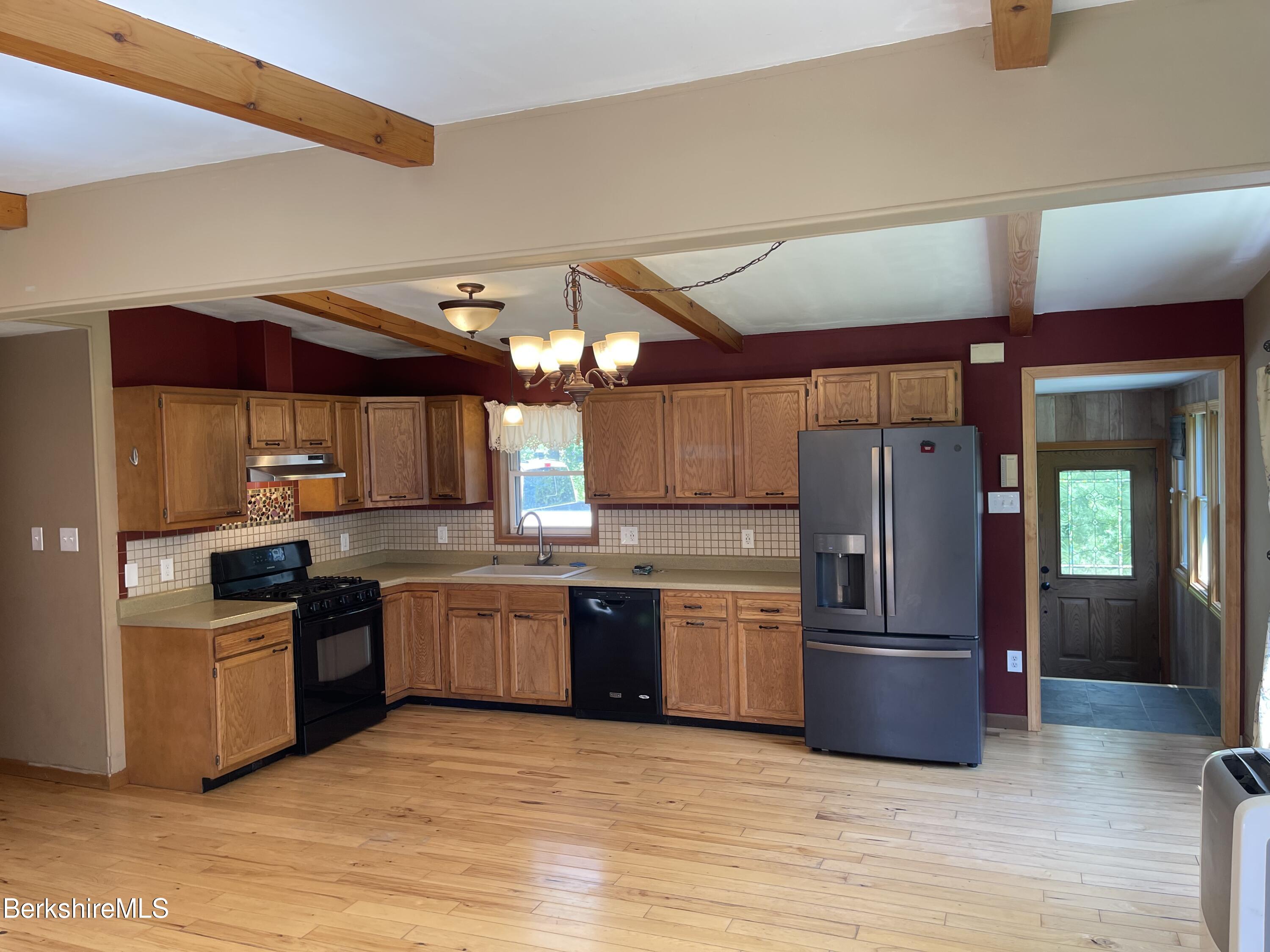 604 Loop Road Savoy, MA 01256 - Photo 4 of 23 a kitchen with stainless steel appliances granite countertop a refrigerator and a sink
