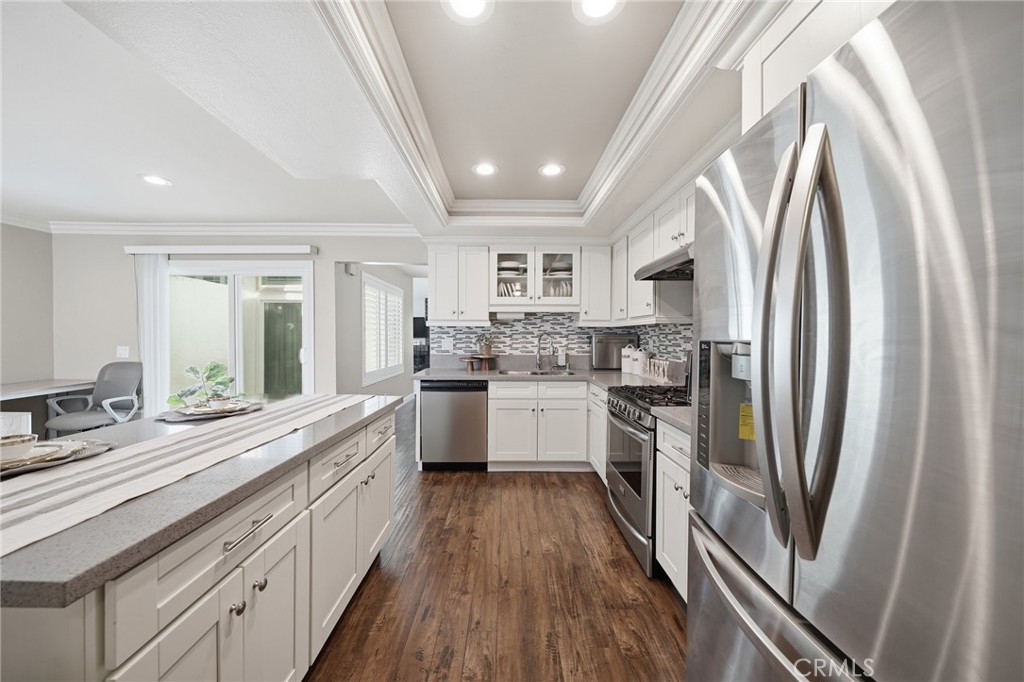 259 Scenic Way Brea, CA 92821 - Photo 11 of 62 a large kitchen with stainless steel appliances granite countertop a refrigerator a sink dishwasher a stove and white countertops with wooden floor