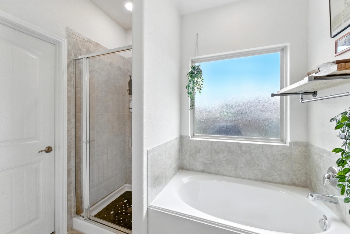 3905 Alpine Autumn Drive Austin, TX 78744 - Photo 11 of 24 Full bath with a garden tub and a stall shower