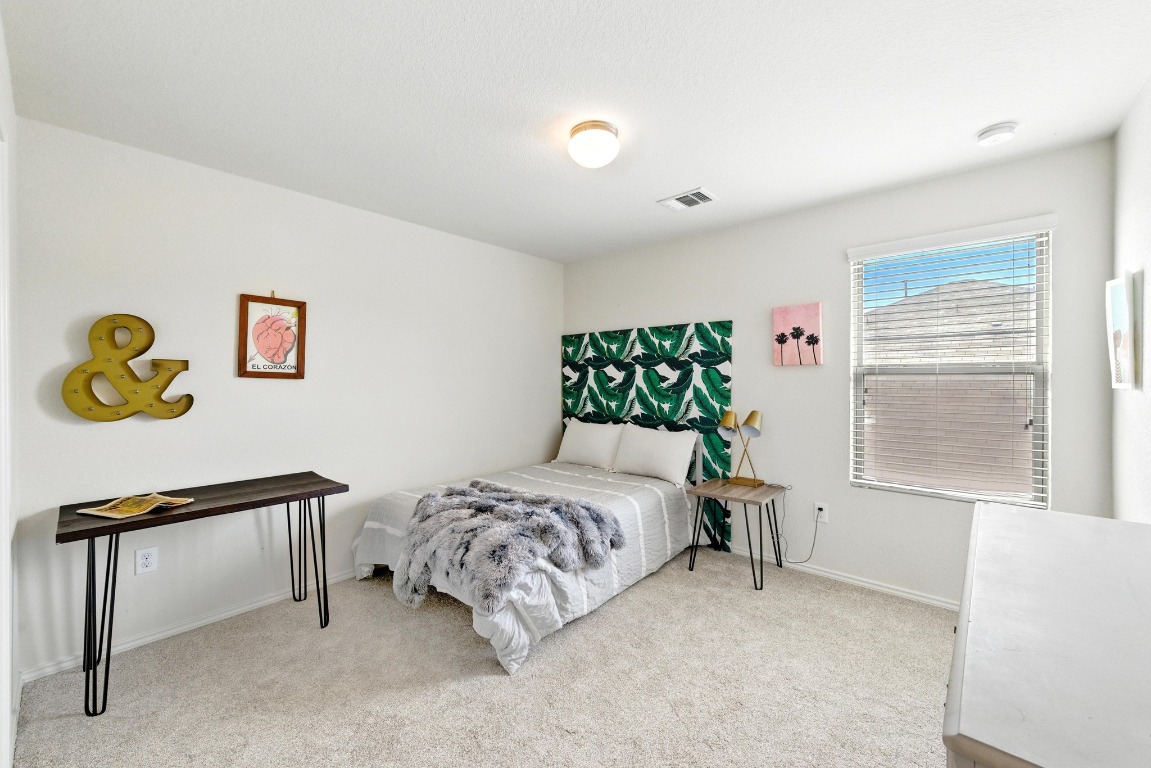 3905 Alpine Autumn Drive Austin, TX 78744 - Photo 14 of 24 Carpeted bedroom featuring baseboards and visible vents