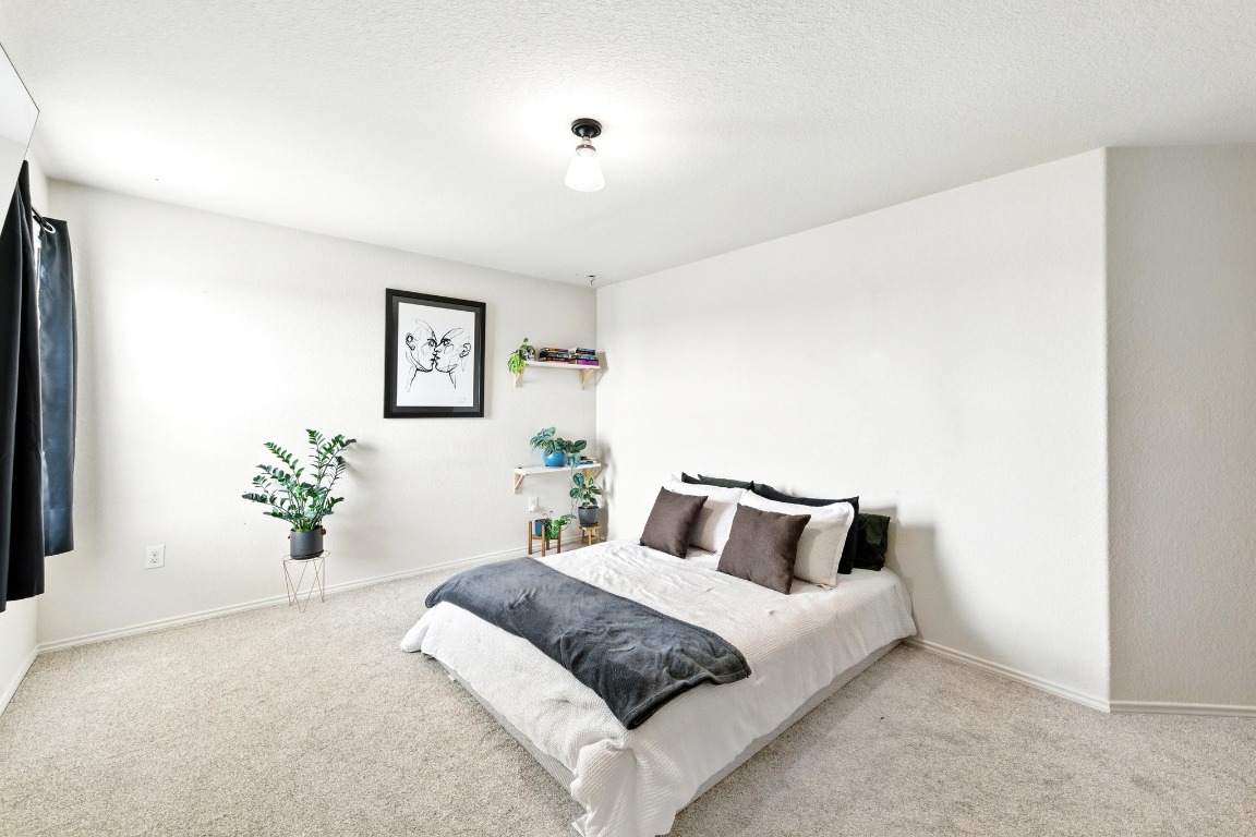 3905 Alpine Autumn Drive Austin, TX 78744 - Photo 15 of 24 Carpeted bedroom featuring baseboards