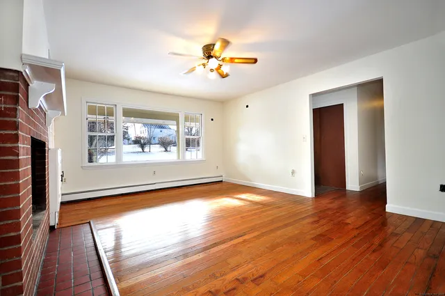 wooden floor in an empty room with a window