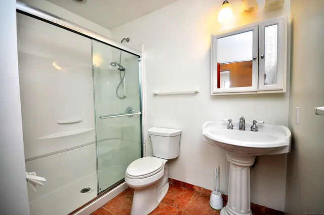 a bathroom with a sink toilet and shower