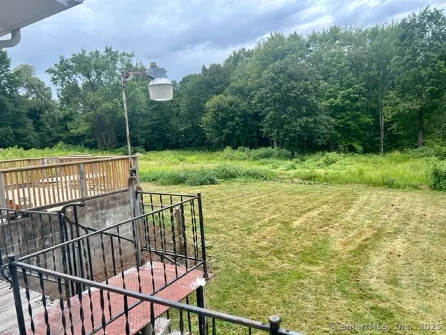 a view of a balcony with a yard