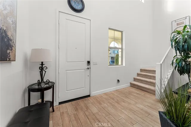 a view of a room with wooden floor and a potted plant