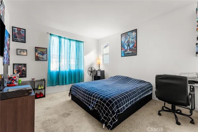 a bedroom with a bed and a chair in it