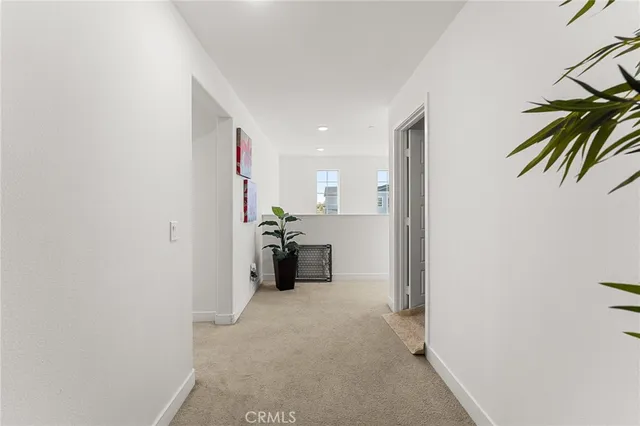 a view of a hallway with a refrigerator