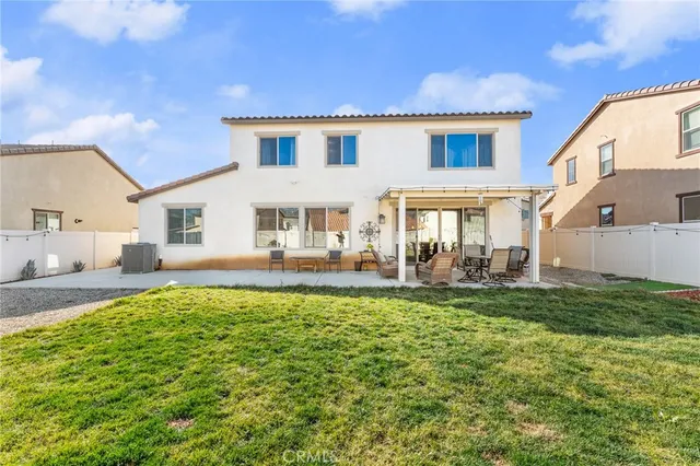 a view of house with swimming pool outdoor seating