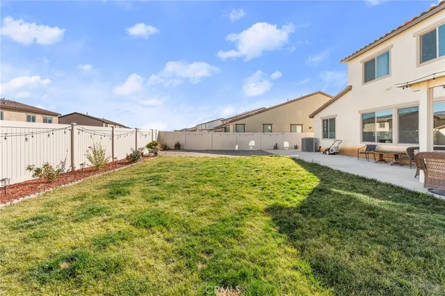 a view of a big yard with table and chairs