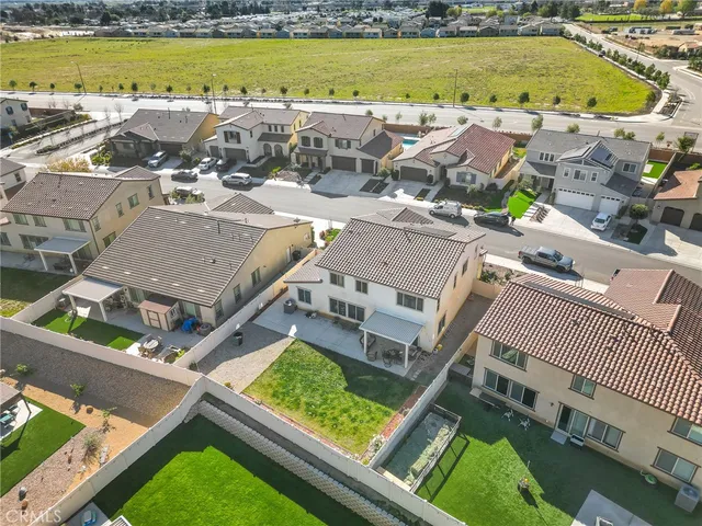 an aerial view of residential houses with outdoor space and swimming pool