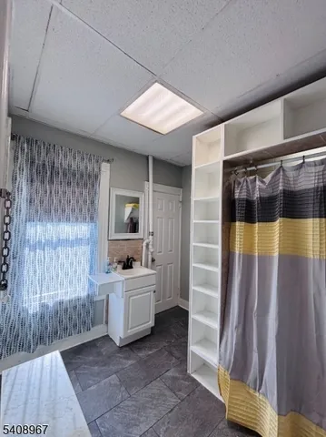 a bathroom with a sink a mirror and a shower