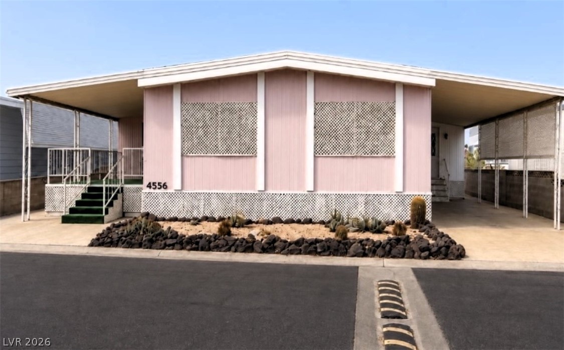 4556 Royal Ridge Way Las Vegas, NV 89103 - Photo 1 of 49 Low-maintenance desert landscaping frames the front exterior, flanked by covered parking and entry steps.