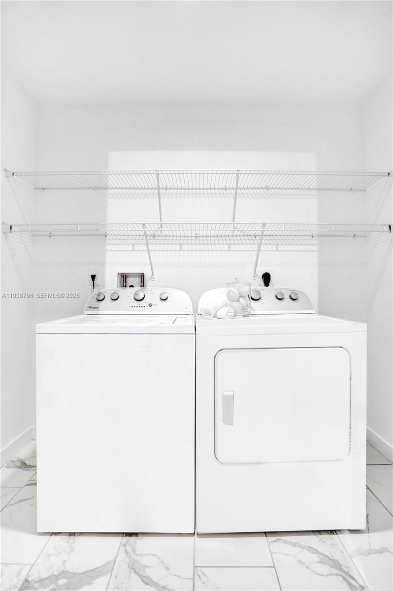 101 East Camino Real, Unit 1025 Boca Raton, FL 33432 - Photo 11 of 12 a utility room with dryer and washer