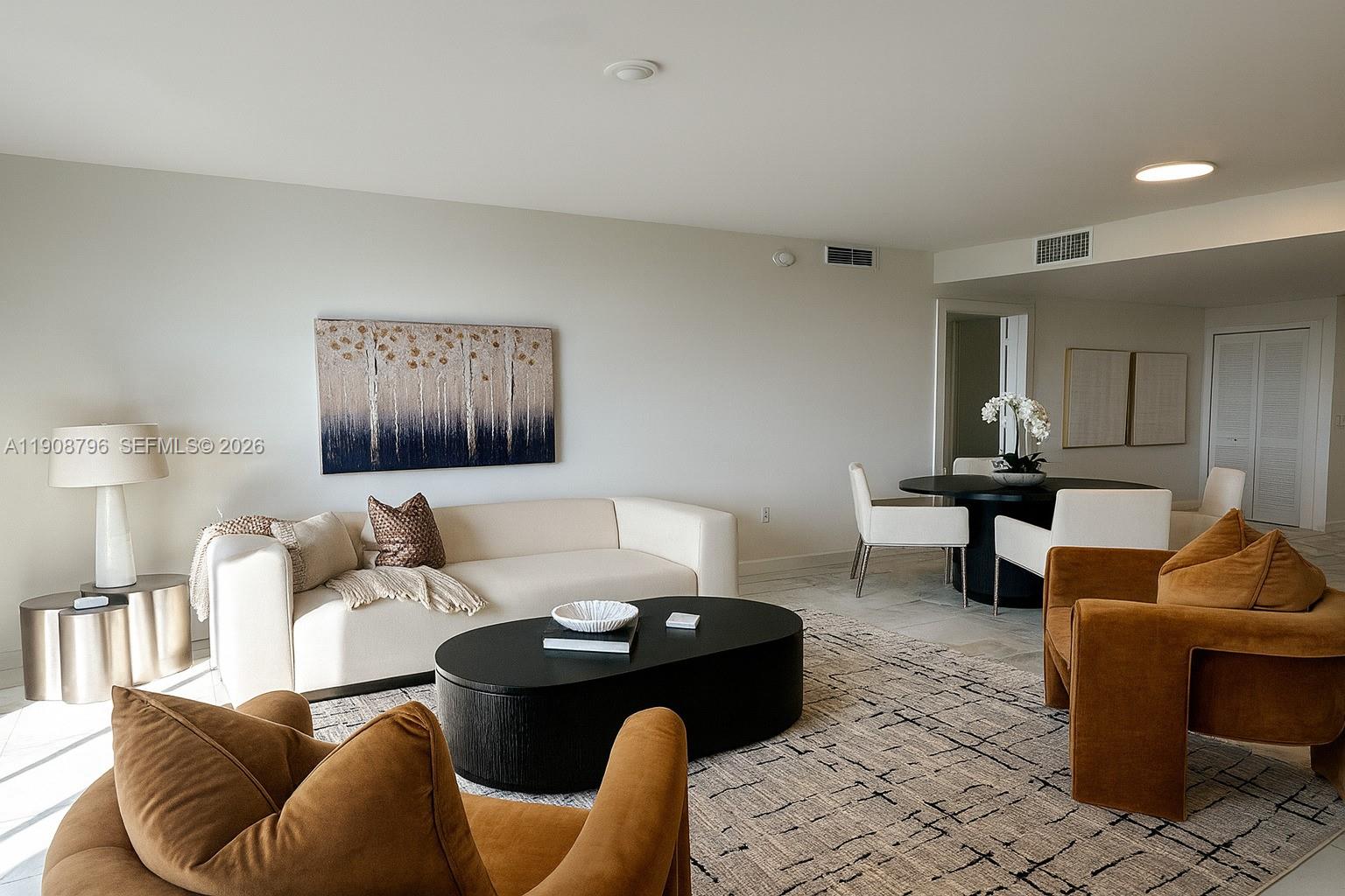 101 East Camino Real, Unit 1025 Boca Raton, FL 33432 - Photo 2 of 12 a living room with furniture and a lamp