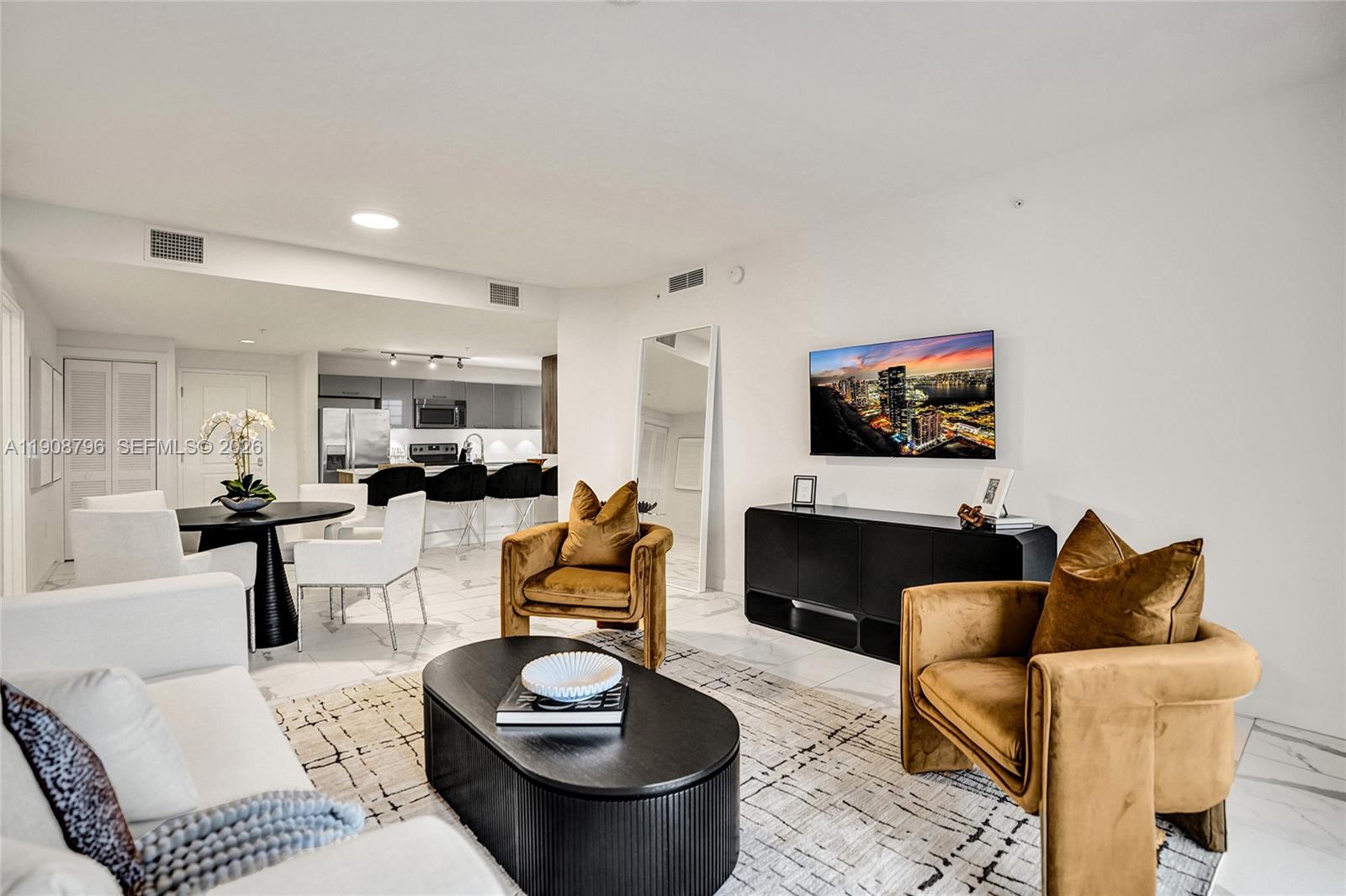 101 East Camino Real, Unit 1025 Boca Raton, FL 33432 - Photo 3 of 12 a living room with furniture and a flat screen tv
