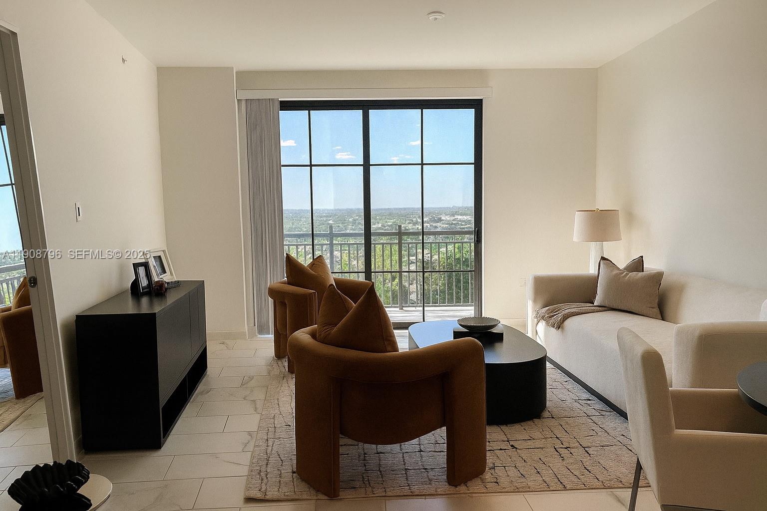 101 East Camino Real, Unit 1025 Boca Raton, FL 33432 - Photo 5 of 10 a living room with furniture and a floor to ceiling window