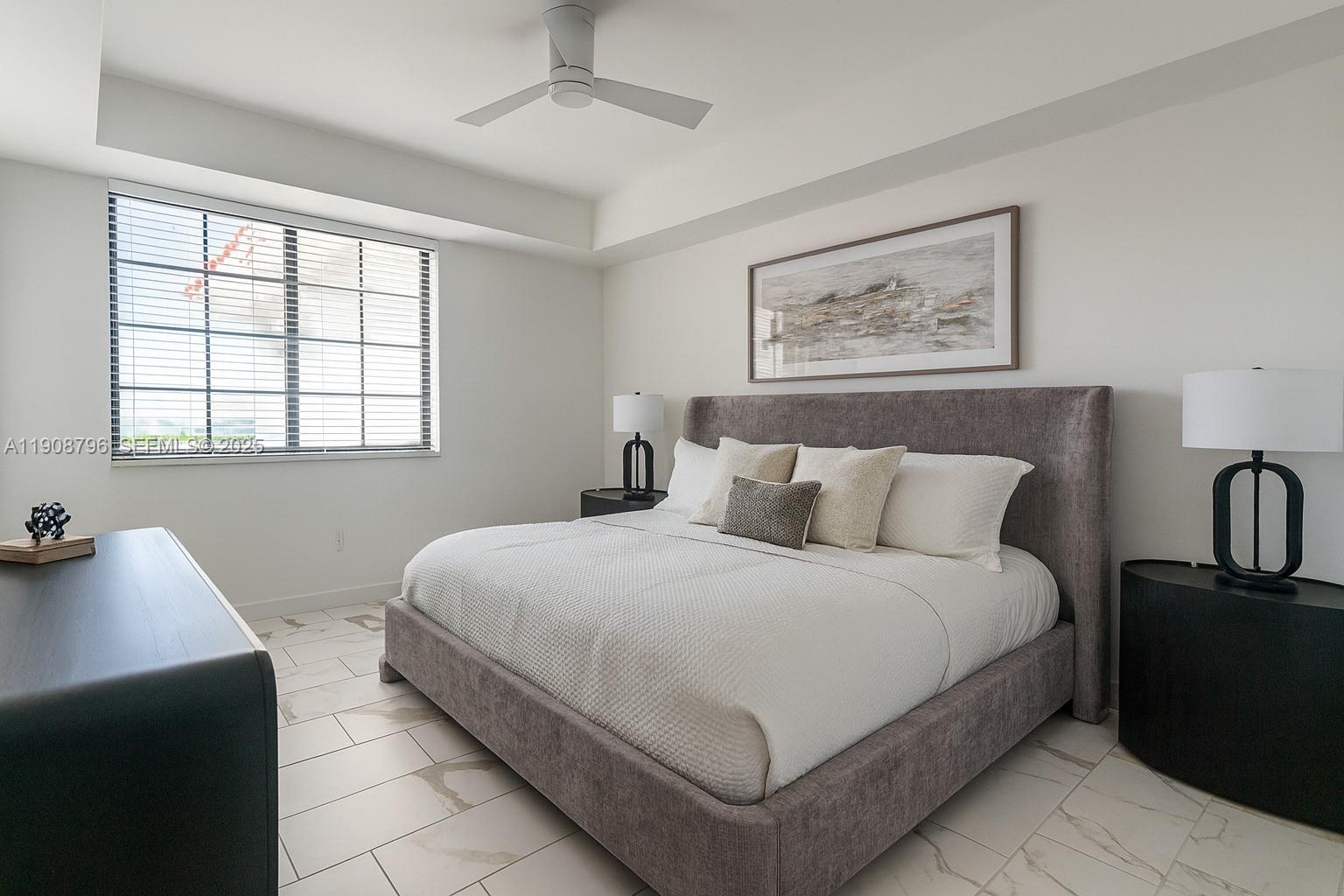 101 East Camino Real, Unit 1025 Boca Raton, FL 33432 - Photo 6 of 10 a bedroom with bed and window
