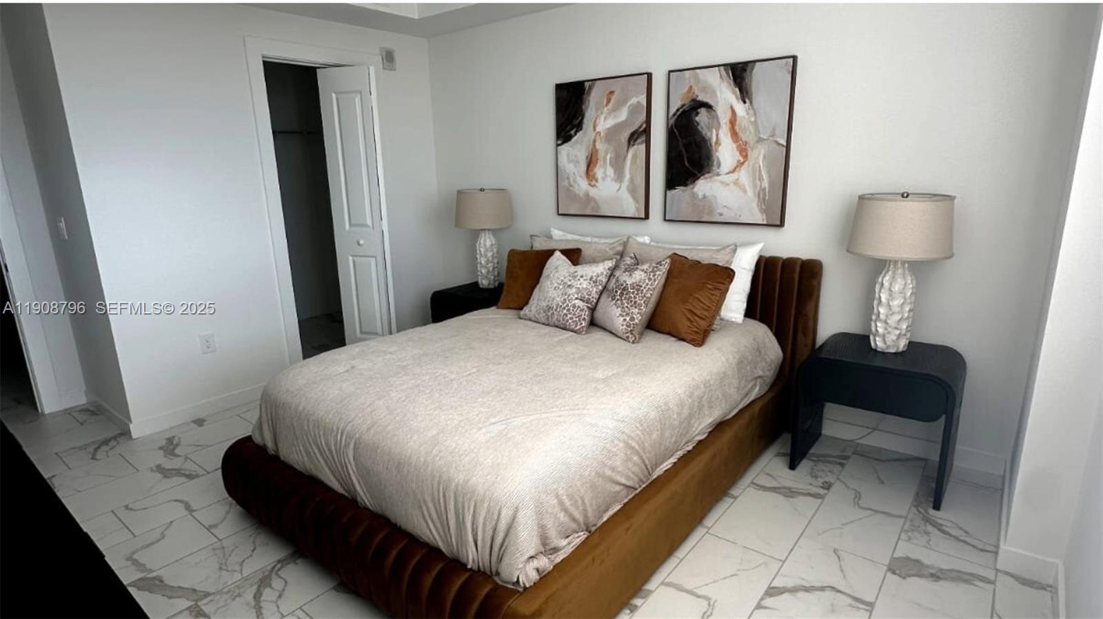 101 East Camino Real, Unit 1025 Boca Raton, FL 33432 - Photo 7 of 10 a bedroom with a bed and a mirror