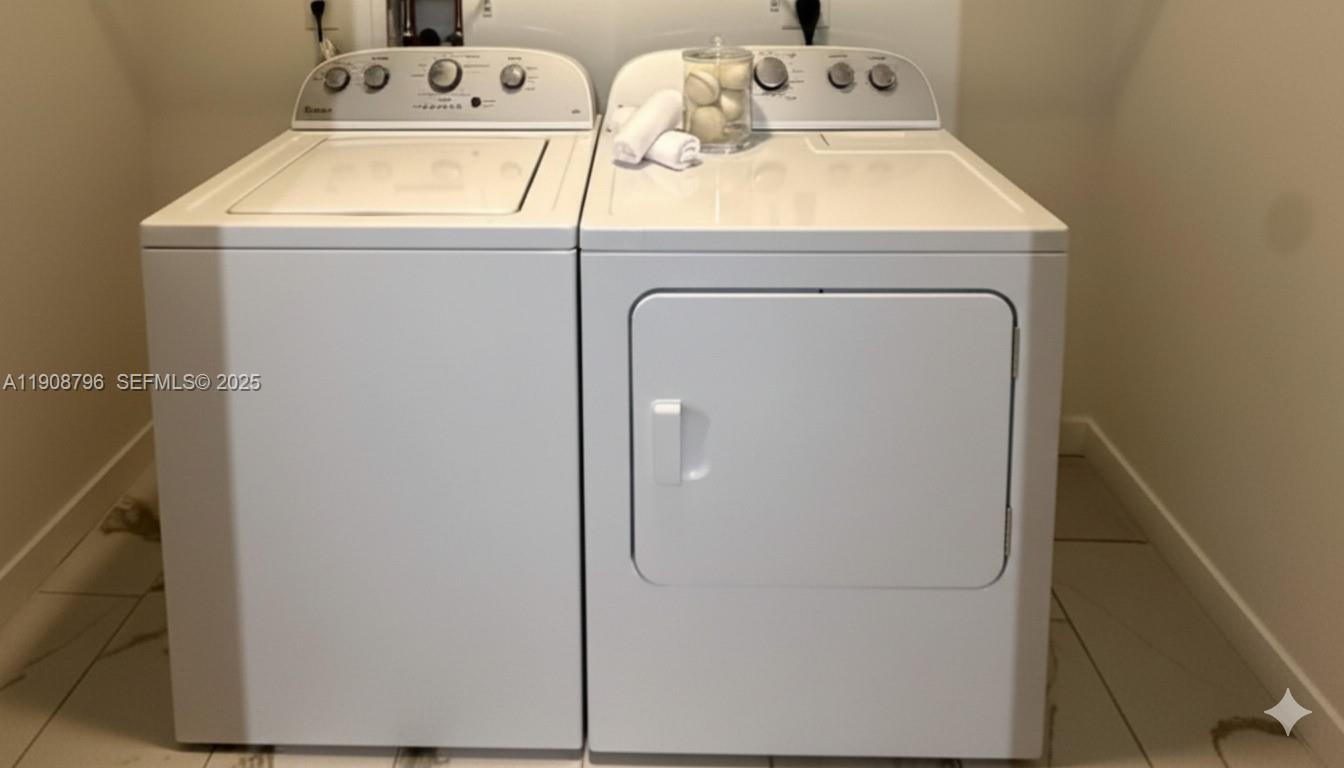 101 East Camino Real, Unit 1025 Boca Raton, FL 33432 - Photo 10 of 10 a utility room with dryer and washer