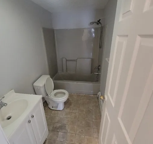 a white toilet sitting next to a bathroom sink