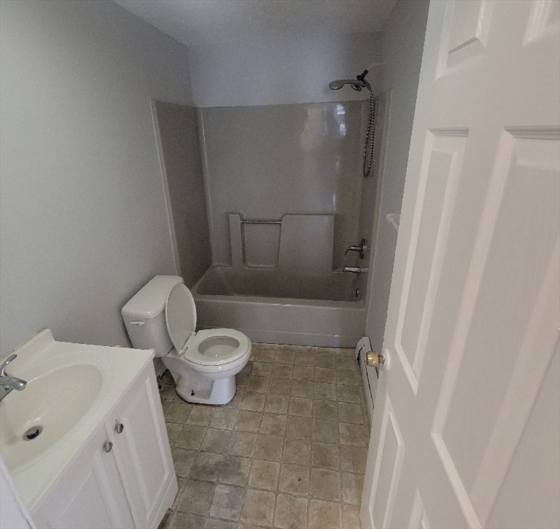 86 Washburn Street, Unit 86 Springfield, MA 01107 - Photo 7 of 8 a white toilet sitting next to a bathroom sink