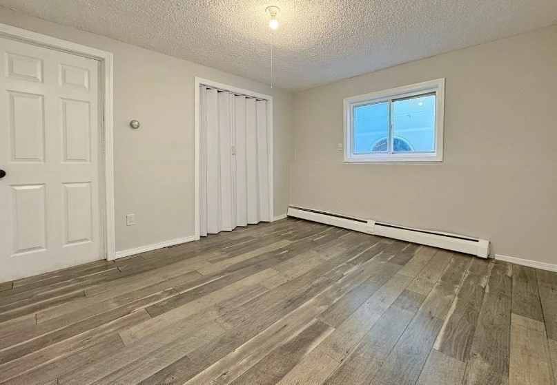 86 Washburn Street, Unit 86 Springfield, MA 01107 - Photo 8 of 8 a view of a room with wooden floor and white walls