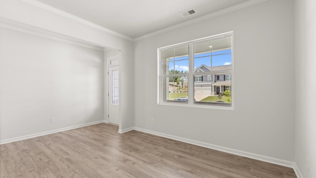 174 Thompson Ridge Lane Dallas, GA 30132 - Photo 5 of 35 a view of an empty room with window and wooden floor
