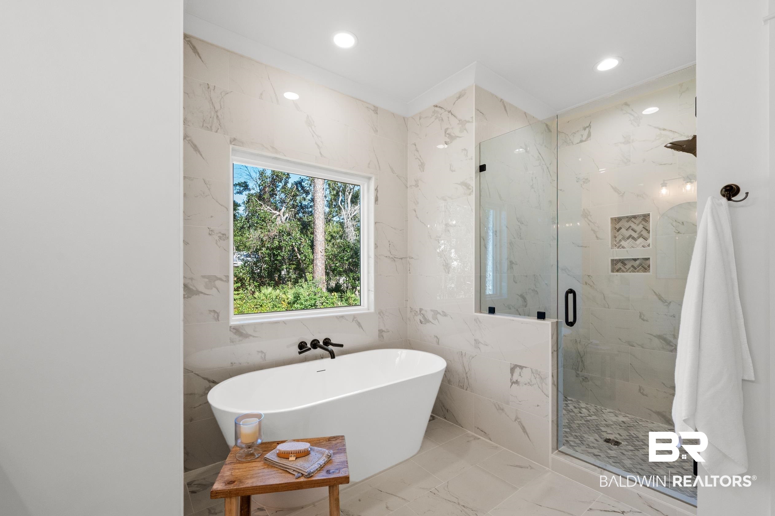 28889 Canal Road Orange Beach, AL 36561 - Photo 40 of 55 Bathroom with tile walls and shower with separate bathtub