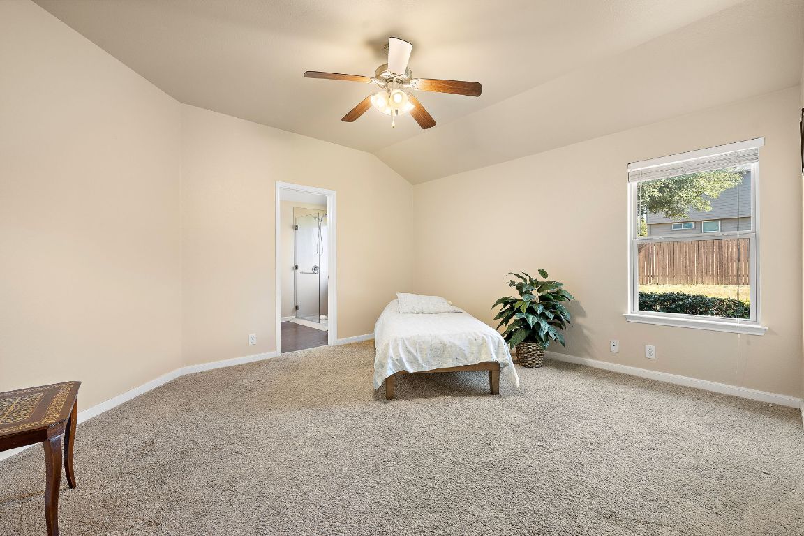 227 Avalanche Avenue Georgetown, TX 78626 - Photo 13 of 27 a bed room with a bed and a chandelier