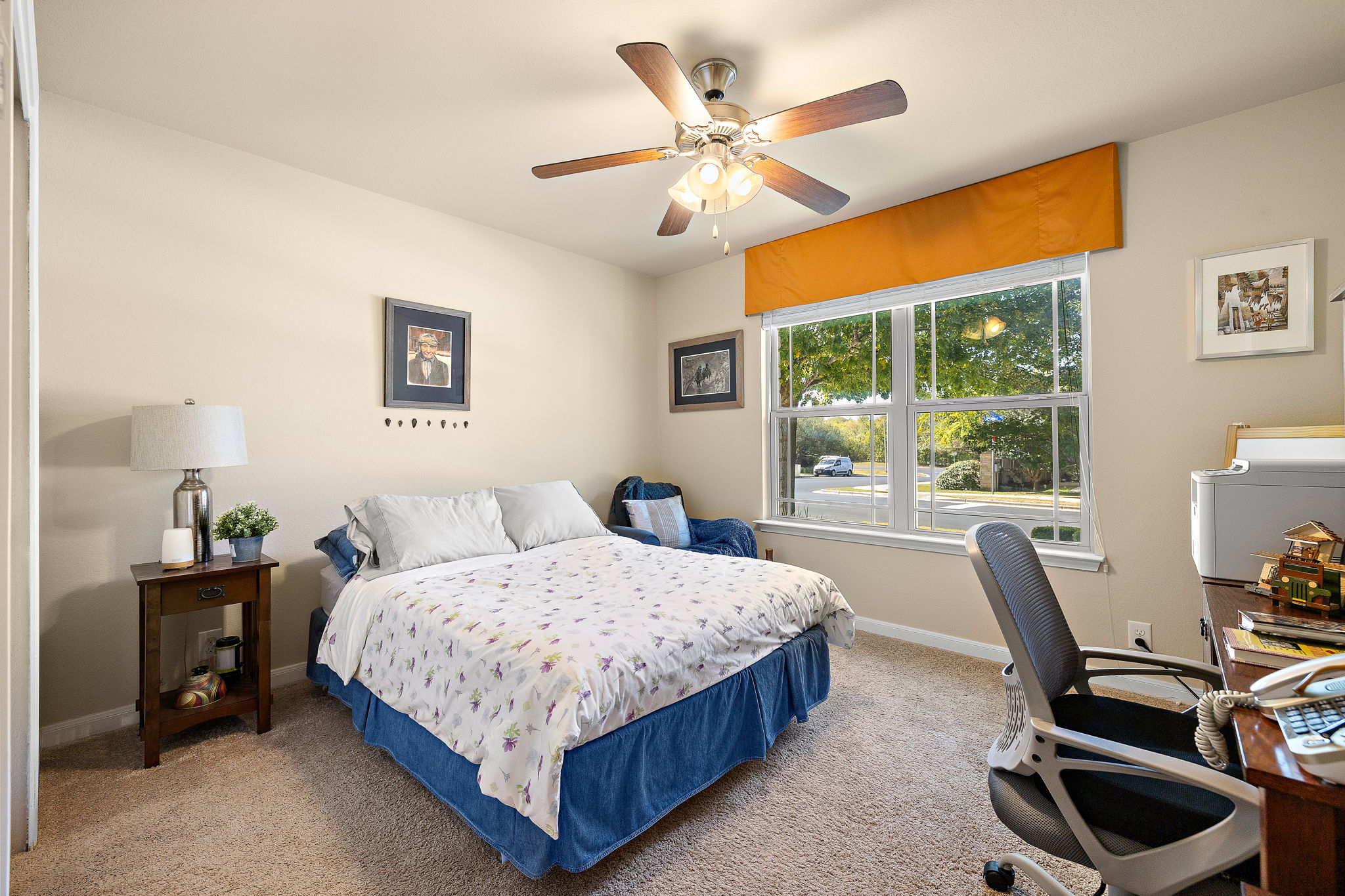 227 Avalanche Avenue Georgetown, TX 78626 - Photo 17 of 27 Bedroom featuring light carpet, a ceiling fan, and an office area