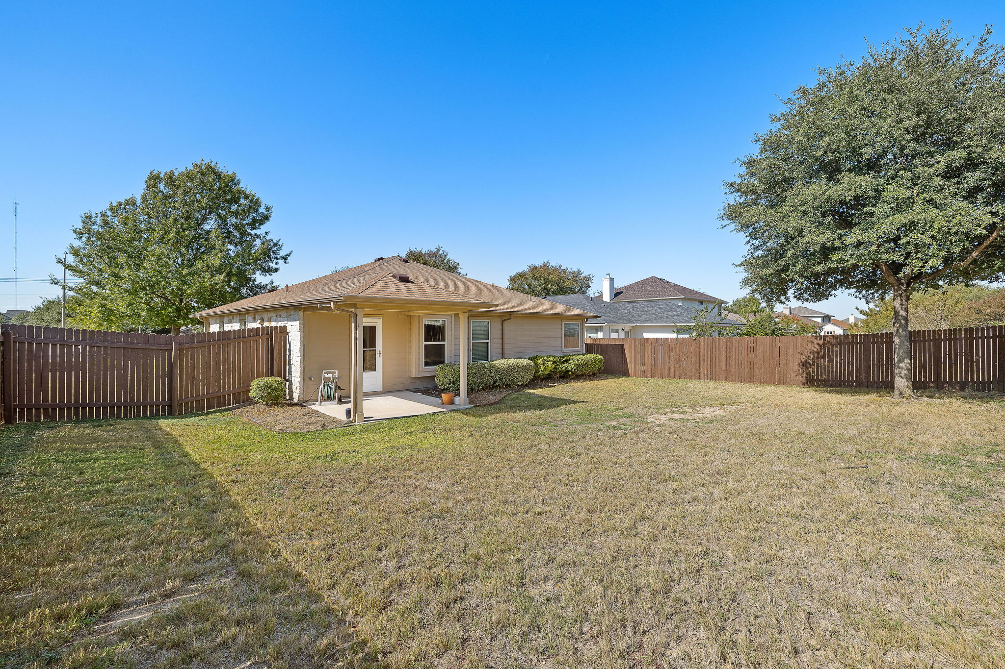227 Avalanche Avenue Georgetown, TX 78626 - Photo 22 of 27 Back of house with a patio and a fenced backyard