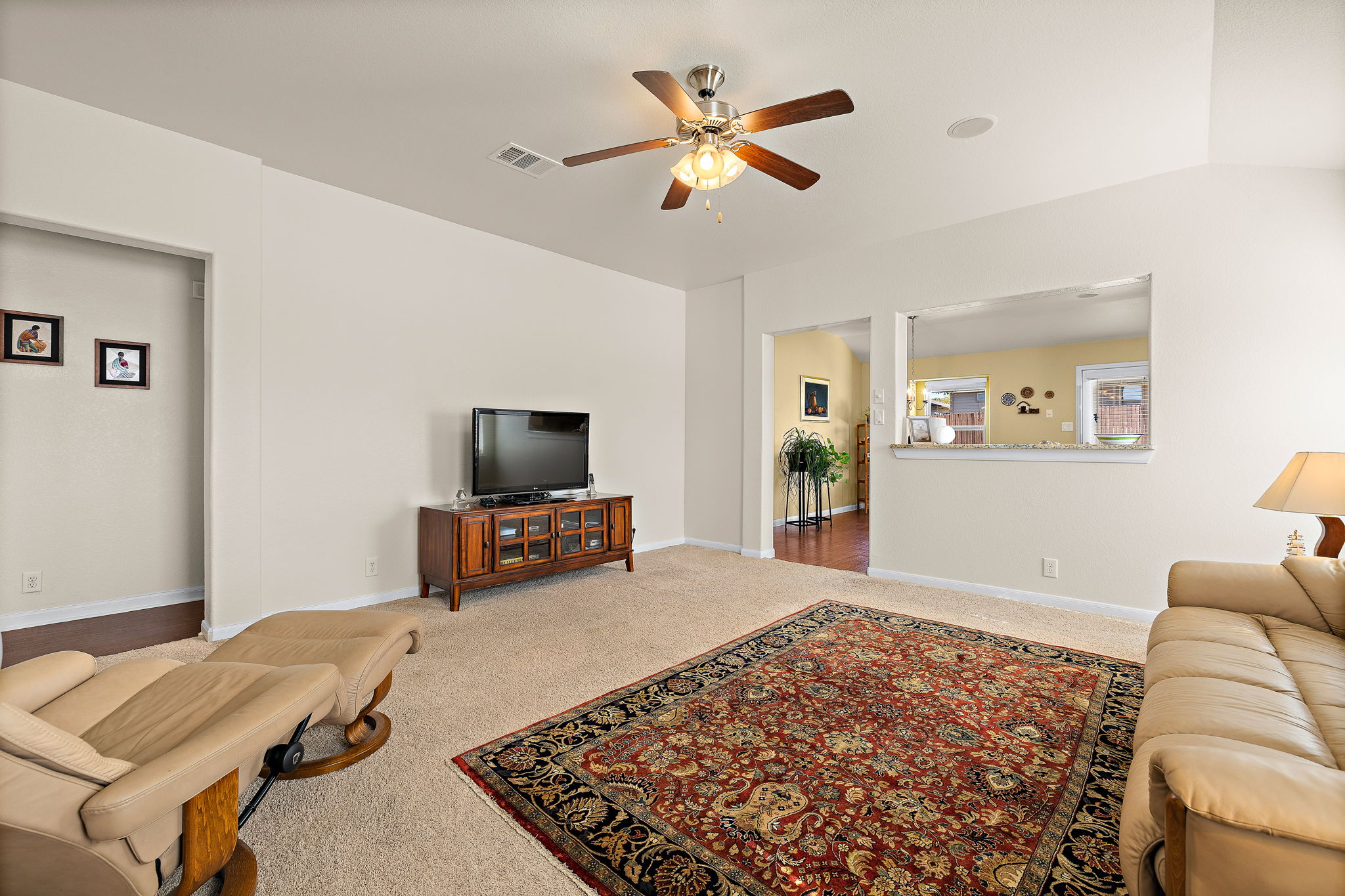 227 Avalanche Avenue Georgetown, TX 78626 - Photo 5 of 27 Carpeted living area with baseboards and a ceiling fan