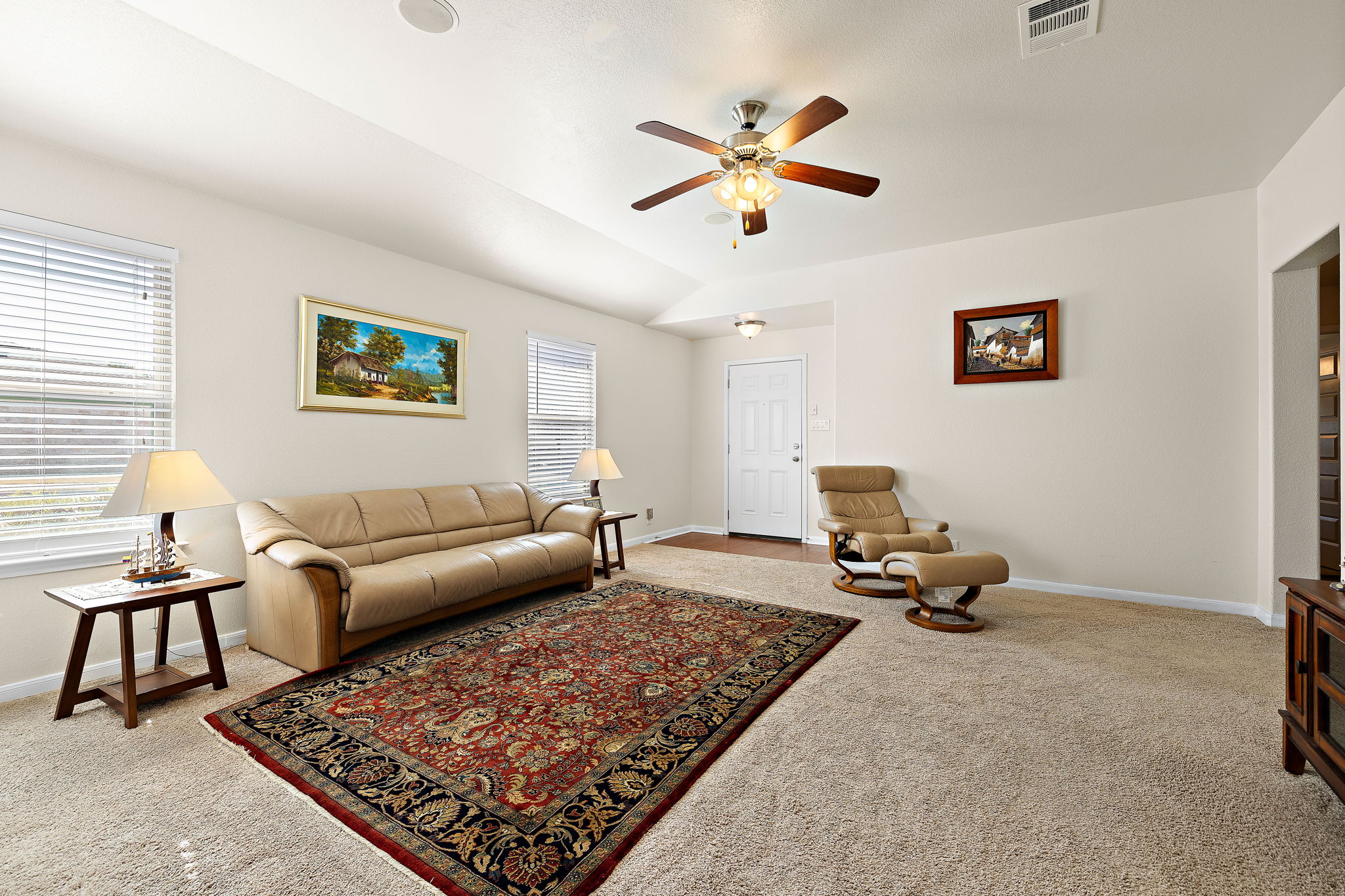 227 Avalanche Avenue Georgetown, TX 78626 - Photo 7 of 27 Living area with light carpet, lofted ceiling, and a ceiling fan