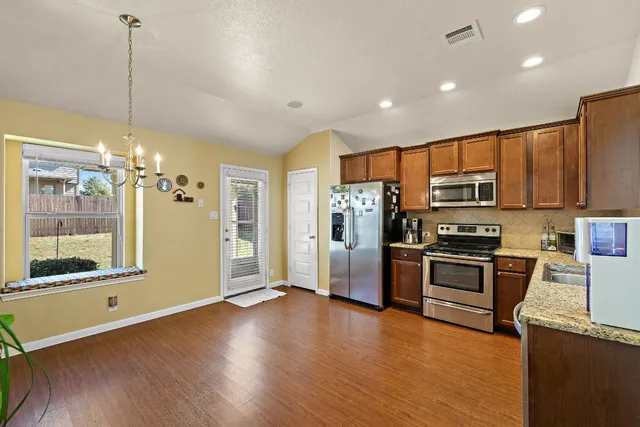 a view of a room with wooden floor and potted plant
