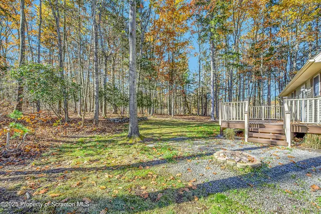 a backyard of a house with lots of green space and fountain