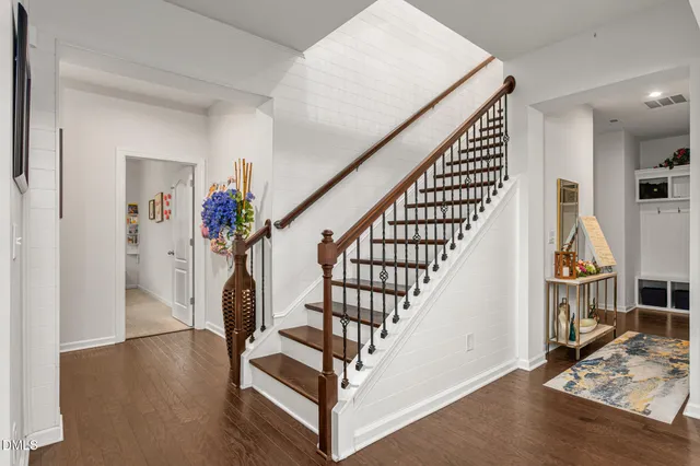 a view of entryway and hall with wooden floor