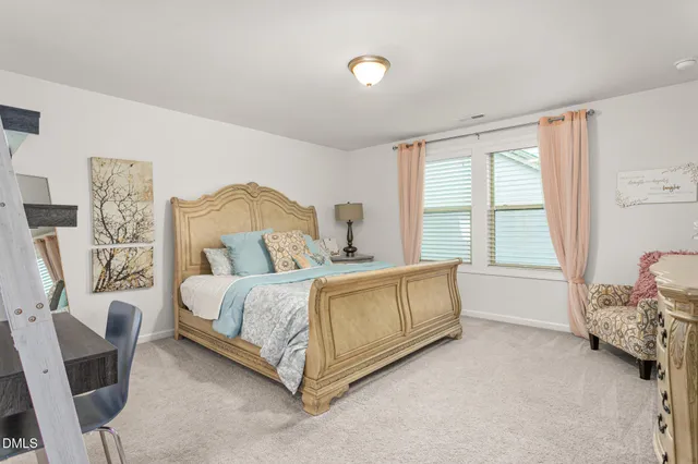 a spacious bedroom with a bed and a window