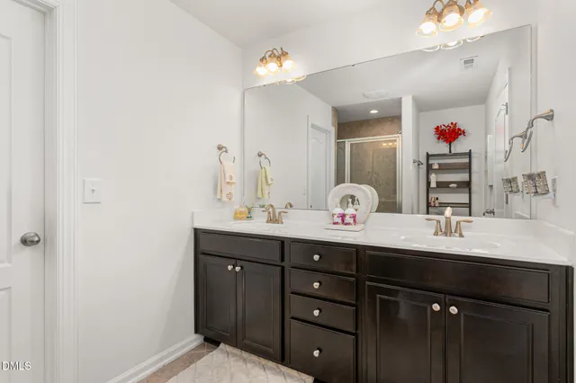 a bathroom with a double vanity sink and a mirror