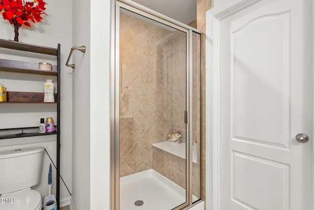 a bathroom with a shower a toilet and a sink