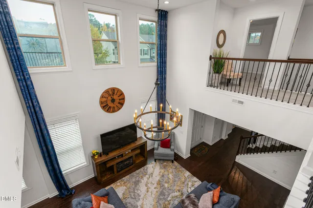 a front view of a house with a yard and potted plants