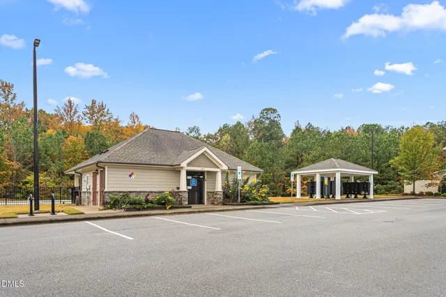 a view of swimming pool with outdoor seating and yard in the back