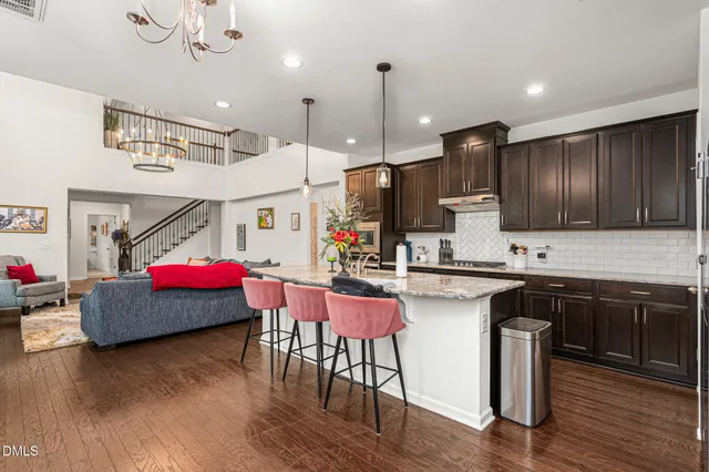 a kitchen with granite countertop a sink cabinets and wooden floor