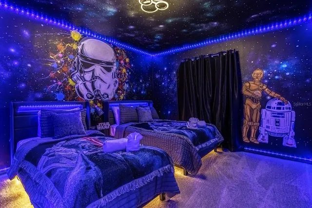 a room with lots of flowers and a chandelier