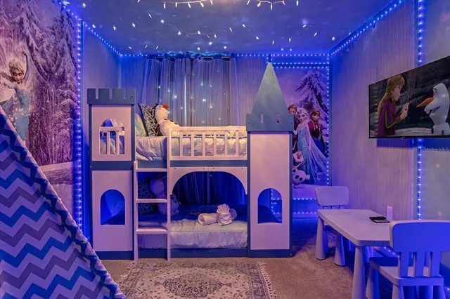 a bedroom with a large bed and a window