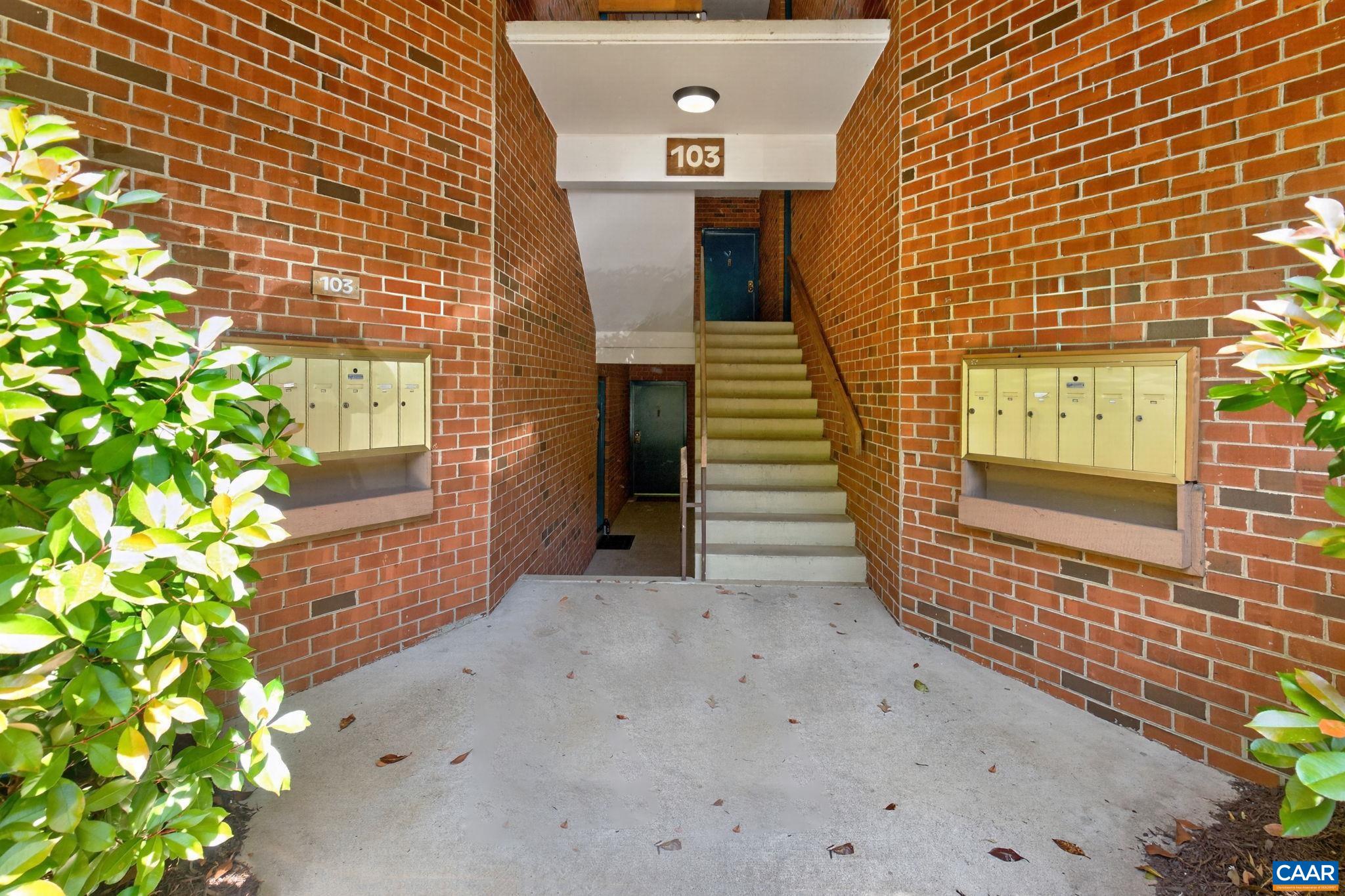 103 Turtle Creek Road, Unit 8 Charlottesville, VA 22901 - Photo 34 of 37 a view of a brick house with a yard
