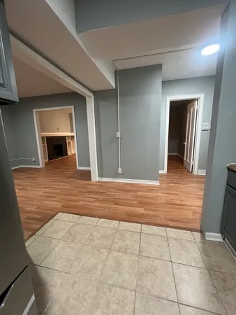 a view of a hallway with wooden cabinet and a fireplace