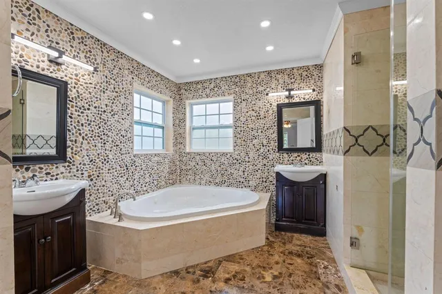 a spacious bathroom with a bathtub sink and mirror