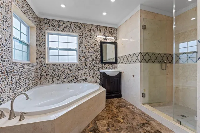 a bathroom with a bathtub and a shower