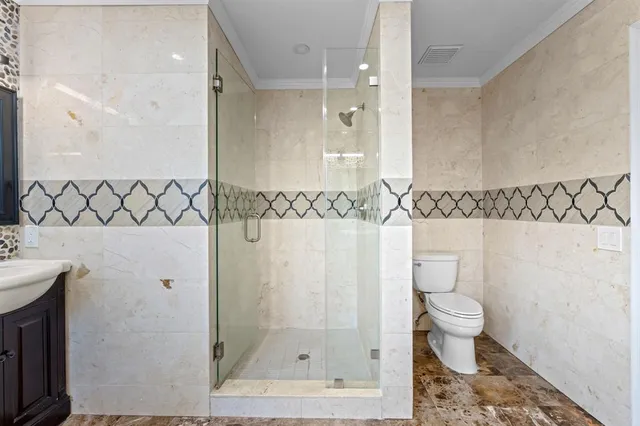 a bathroom with a shower toilet and a sink