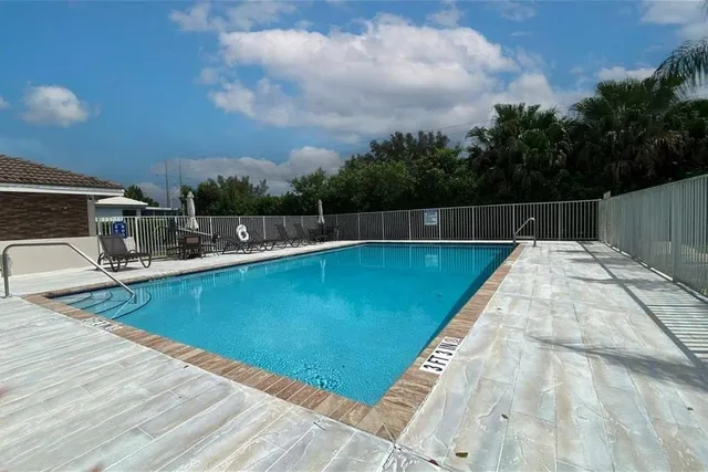 a view of a swimming pool with a yard